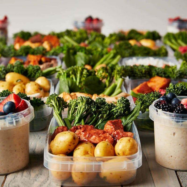 Macro Based Diet 1800 Calorie Meal Package featuring portioned meals with seasoned potatoes, grilled chicken, fresh broccoli, and yogurt parfaits, ideal for muscle gain and balanced eating.